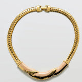 Vintage Napier gold-tone and blush enamel collar necklace on a light gray background