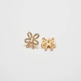Front and back views of vintage pavé gold bow earrings on a light gray background