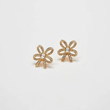 Pair of vintage pavé gold bow earrings on a light gray background