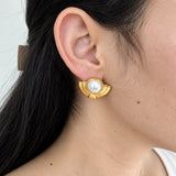 Vintage Monet pearl-look Deco stud earrings — on-ear view