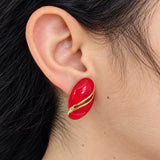 Vintage Monet red oval clip-on earring — on-ear view
