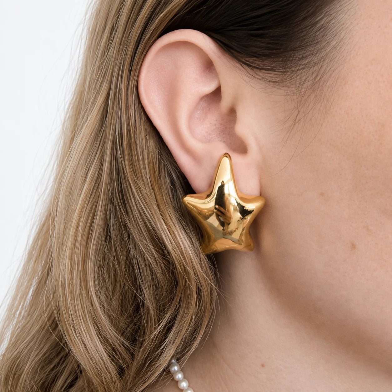 Vintage sculptural star clip-on earrings worn on model