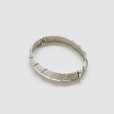 Vintage silver-tone textured hinged bangle — angled clasp view