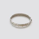 Vintage silver-tone textured hinged bangle — closed front view