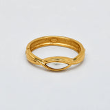 Vintage gold-tone hinged bangle with white oval centerpiece — closed