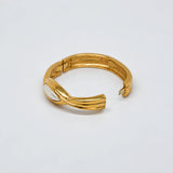 Vintage gold-tone hinged bangle with white oval centerpiece — open clasp