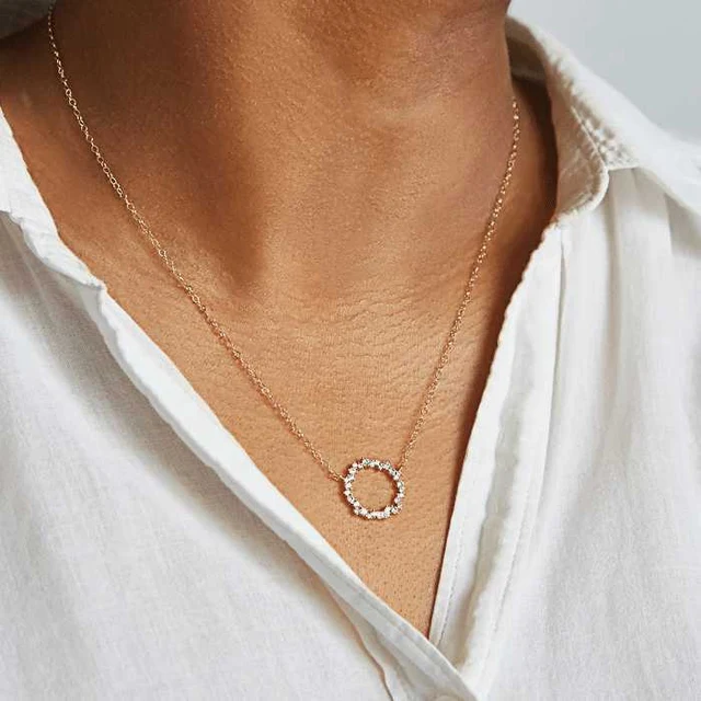 Gold crystal circle pendant necklace styled with a white shirt