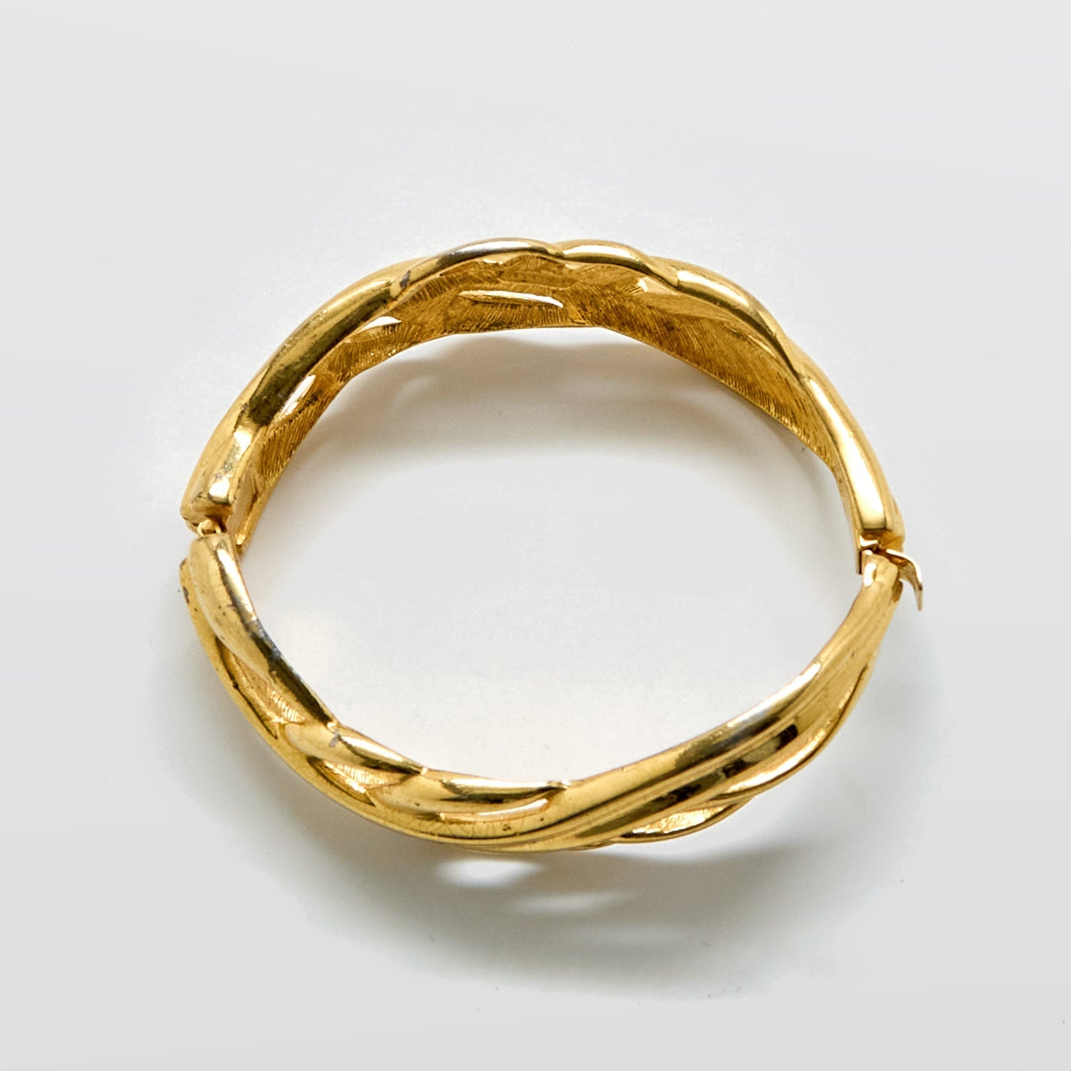 Gold bracelet on a white background
