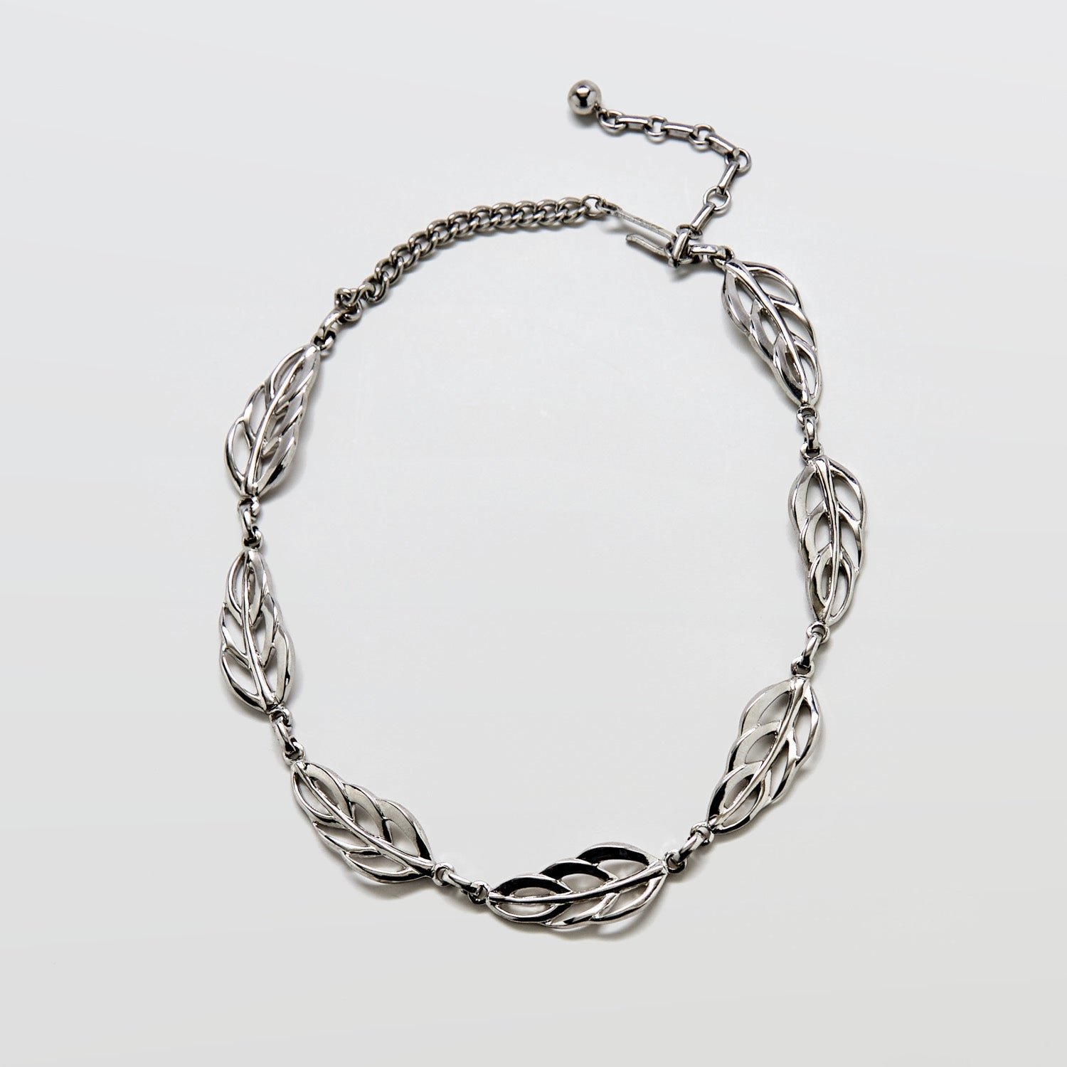 Full view of vintage Barclay silver-tone choker necklace featuring linked openwork leaf motifs and adjustable chain.