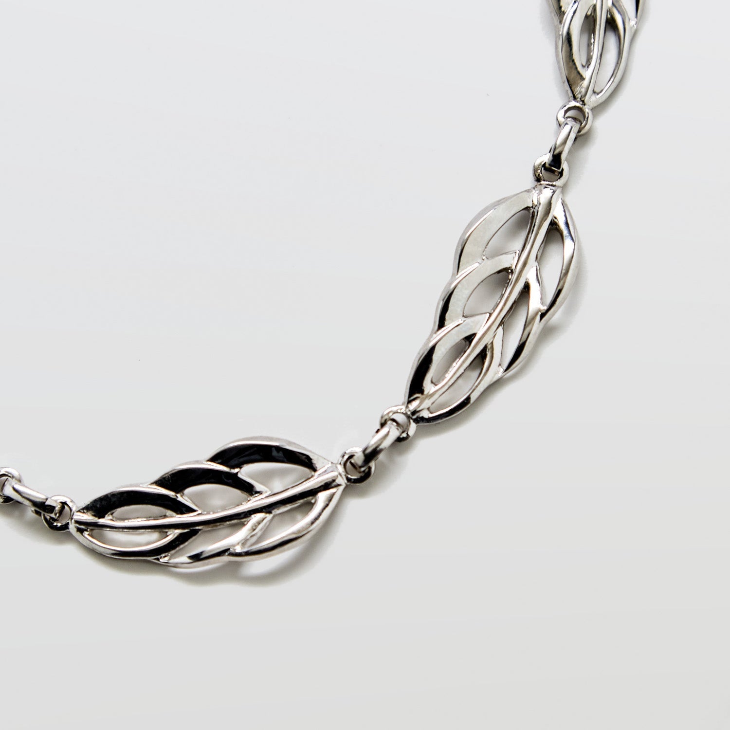 Close-up of vintage Barclay silver leaf necklace showing detailed openwork link design and polished silver finish.