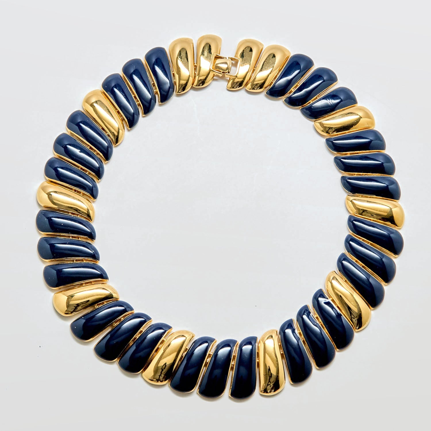 Necklace with blue and gold beads on a white background