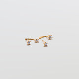 Gold Double CZ Stud Ear Jacket Earrings with cubic zirconia studs and curved ear jacket backing on white background.