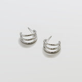 Pair of silver hoop earrings on a light gray background