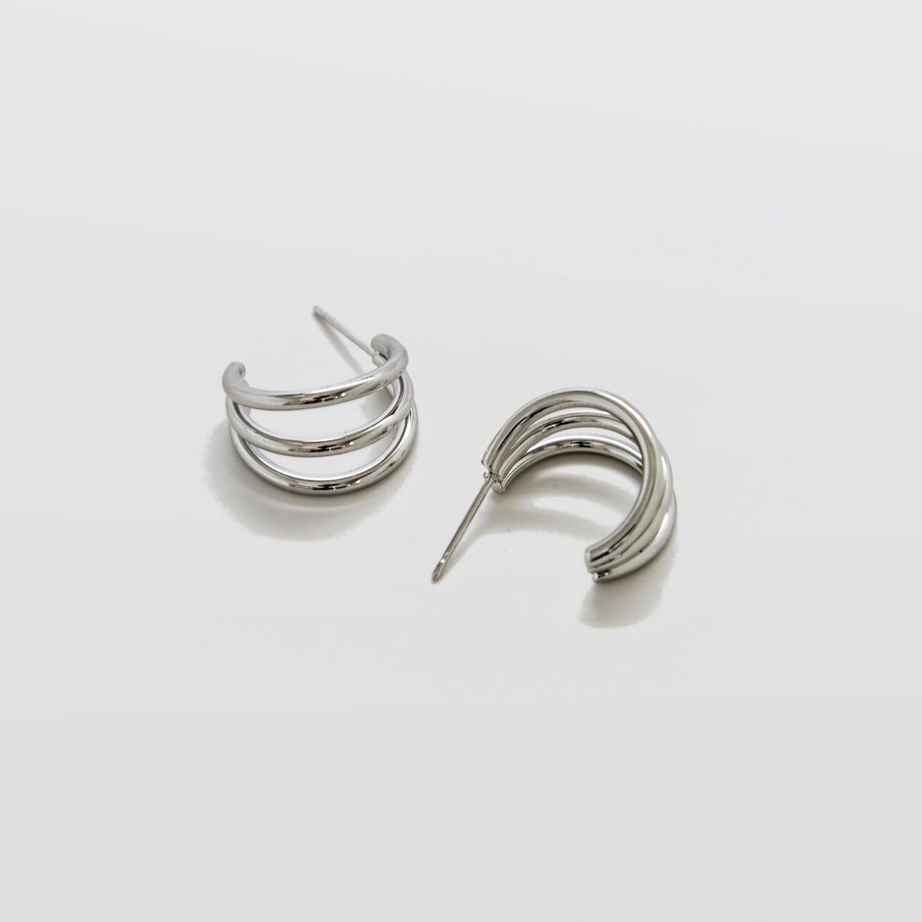 Pair of silver hoop earrings on a light gray background