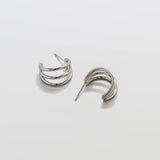 Pair of silver hoop earrings on a light gray background