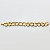 Gold chain bracelet on a light gray background